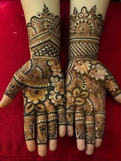 A bold and beautiful floral mehndi for the Sawan season. This design uses negative space to make the large flower and leaf motifs pop, covering the hands in a rich pattern.