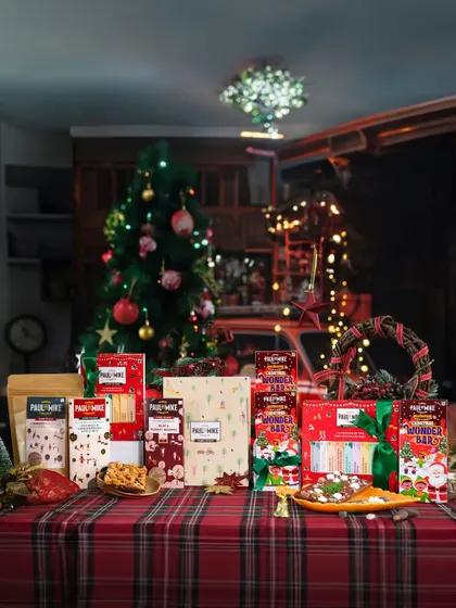 A wide shot of a fully decorated Christmas table featuring an entire range of a brand's festive products.