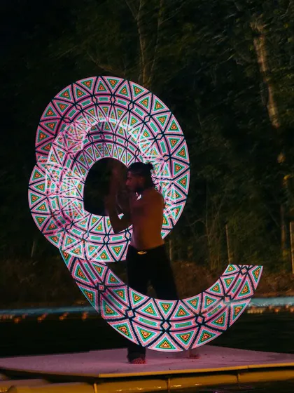 Another stunning pattern from the LED poi performance. The artist's fluid movements create a captivating visual experience for the festival attendees.