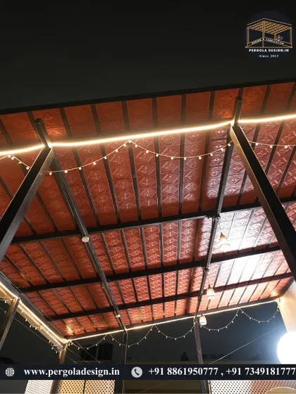 A close-up of the Mangalore tile ceiling with integrated LED strip lighting and decorative string lights. This combination of traditional materials and modern lighting creates a unique and festive ambiance.