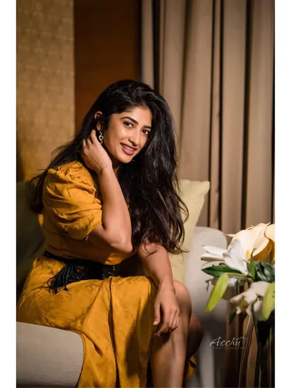 A relaxed, seated portrait that feels comfortable and authentic. This is a great example of a lifestyle portrait that captures personality in a natural setting.