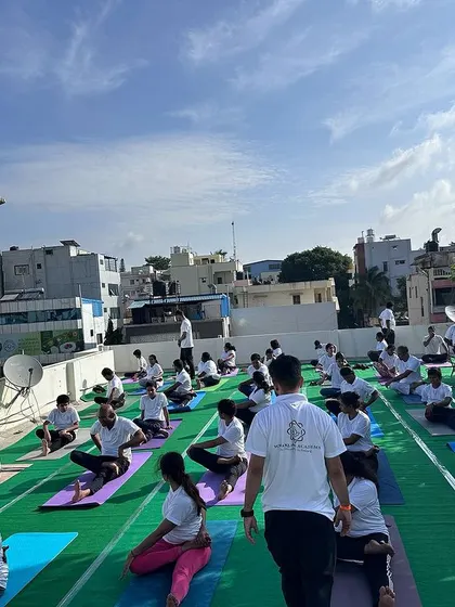 A wide shot of our rooftop yoga class in Bangalore, showing the scale of our community and the shared experience of practicing together under the open sky.