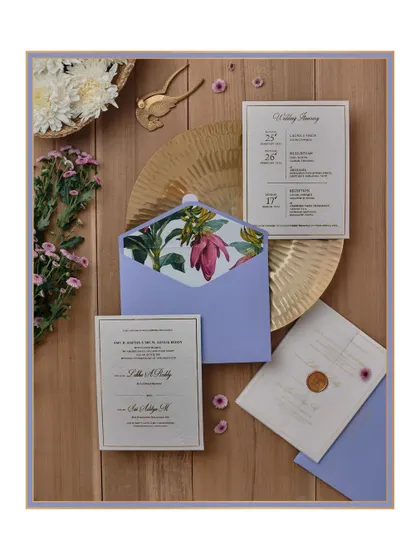 Minimal elegance is captured in this design featuring delicate banana tree illustrations. The details are finely printed, and the suite is presented in a lovely periwinkle blue envelope with a custom liner.