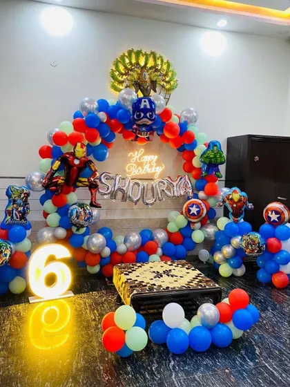 An action-packed Avengers superhero theme for a 6th birthday, with character balloons like Iron Man and Captain America, and a glowing number sign.