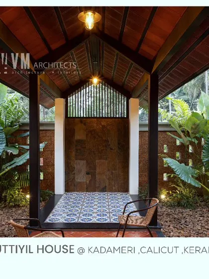 This covered outdoor seating area at Kuttiyil House, known as a 'majlis' space, allows guests to be welcomed in a garden-like setting, blending traditional hospitality with nature.