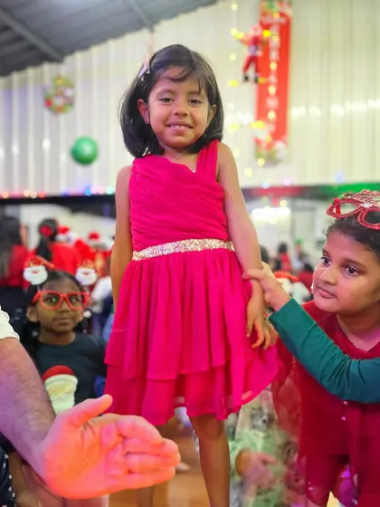 A helping hand from a friend. Our community is built on support, and here, friends help the birthday girl during her celebration.