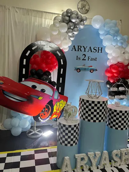 A full view of the car racing theme, showing the complete balloon arch and prop arrangement, perfect for a young car enthusiast.