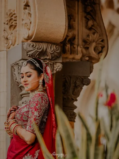 A soft, beautiful portrait of the bride, focusing on the details of her outfit and the palace architecture.
