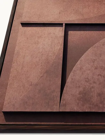 A close-up of the Rust Relief sculpture, detailing the textured finish and the sharp, clean lines of the geometric composition.