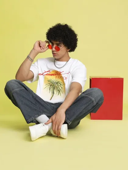 Here, I styled a casual, summery look with a graphic tee and relaxed-fit jeans against a bright yellow backdrop. The red-tinted glasses add a pop of color and personality, perfect for a youthful brand.