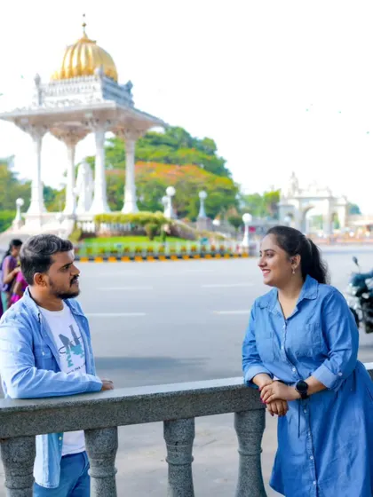 A relaxed pre-wedding moment captured near Mysore Palace. The iconic background adds a sense of place and history to their story.