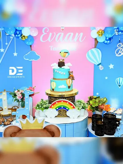 The cake table at Evaan's party, featuring a stunning multi-tiered cake that perfectly matches the hot air balloon theme.