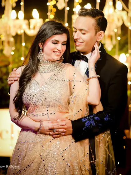 A tender and romantic moment from an engagement party. The groom holds his bride-to-be close, and her gentle touch on his face shows their deep connection.