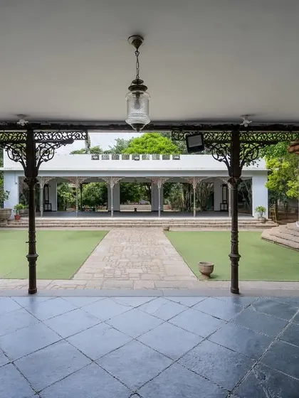 A view of the grand lawn and our colonial bandstand, framed by antique pillars. This open space is perfect for large ceremonies, offering a sense of scale and history.