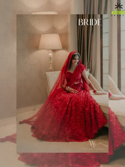 A portrait of the beautiful bride in her radiant red lehenga, captured in a quiet moment before the ceremony begins.