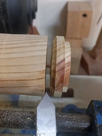 Parting off the lid from the main body of the box on the lathe. This is a delicate operation that requires a steady hand.