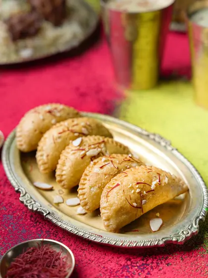 Colorful Gujiya for a Holi campaign. The vibrant background and festive styling make this a joyful and celebratory shot, perfect for seasonal brand content.