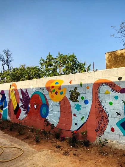 A section of the wholesome community wall art mural with Project Defy, featuring a creative octopus and other whimsical elements designed and painted with the kids.