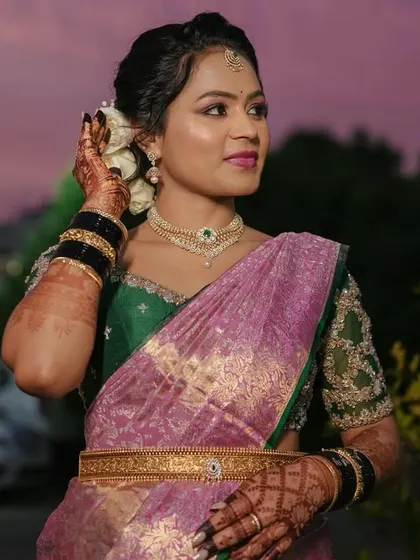 A close-up of Harshitha, her makeup and jewelry perfectly complementing her reception outfit.
