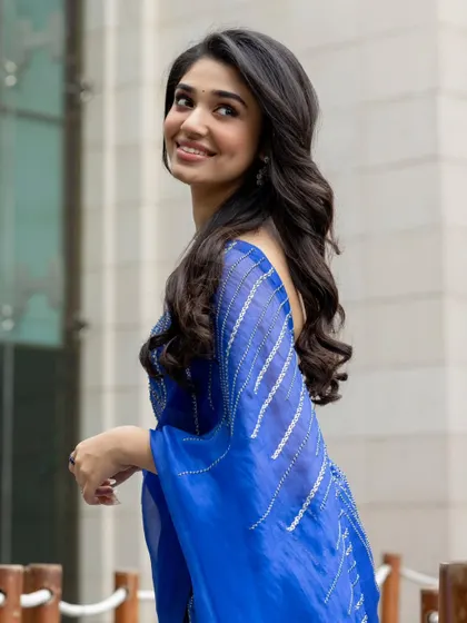 Krithi Shetty looks absolutely lovely in this royal blue organza saree. The minimalist striped blouse keeps the look fresh and modern, perfect for a formal event.