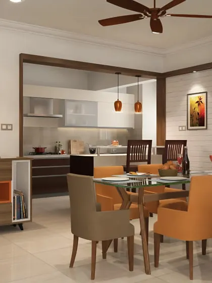 An open-plan dining area with a glass-topped table and cheerful orange chairs. The space feels connected to the kitchen, perfect for modern family living.