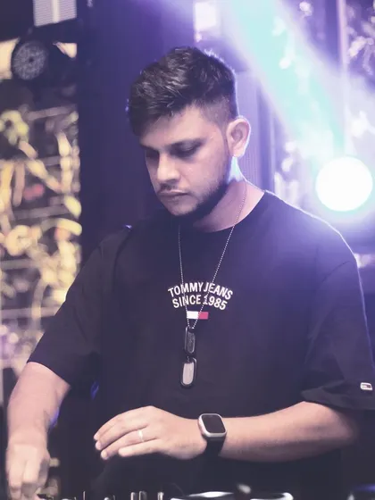 A profile shot of me focused on the controls. Every event gets my full attention to detail to ensure the music is just right.