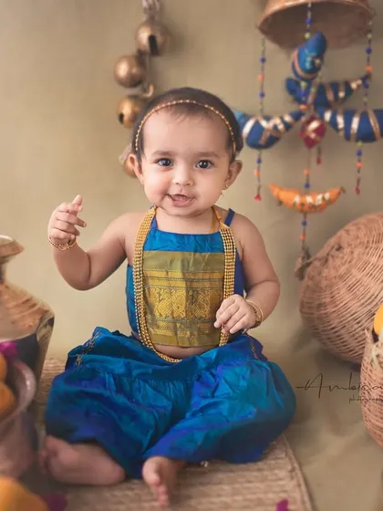 A happy wave from this little one during her unique, mango-themed photoshoot. Her smile brings so much life and warmth to this culturally inspired portrait.