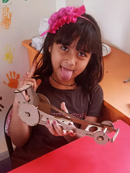 This student shows off her personality and her awesome wooden car project.