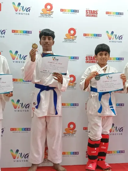 More winners from the Interschool Championship. Students of different belt levels, from yellow to blue, all achieving success through dedication.