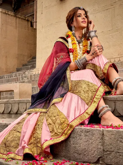 A beautiful, candid-style shot of the pink Navratri lehenga. The silver anklets and toe rings complete the traditional look from head to toe.