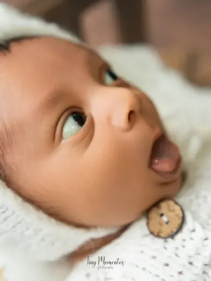 A playful moment as the baby sticks out their tongue. These spontaneous expressions make for unforgettable and fun photos.