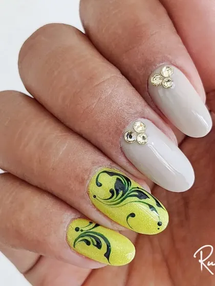 A bold combination of neon yellow swirl art with classic nude nails accented by gold crystals. This design is for someone who isn't afraid to stand out.
