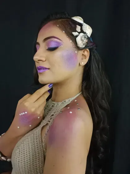 This shot shows the scale effect on the hand and shoulder, demonstrating how to extend fantasy makeup beyond the face for a more complete character transformation.