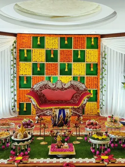 A colorful baby shower setup with a marigold checkerboard backdrop in green, yellow, and orange, creating a festive and cheerful atmosphere.
