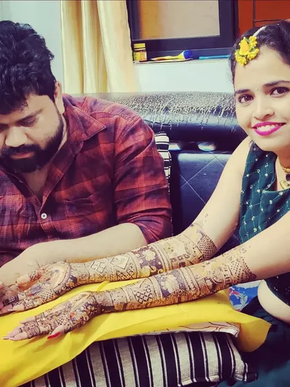 A happy client and me after a successful mehndi session. Seeing the joy on a bride's face when she sees her finished henna is the best part of my job.