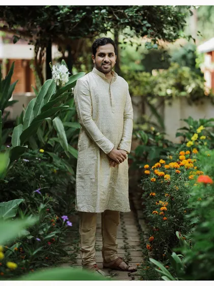 A handsome portrait of the groom in his simple cream kurta, ready for the Haldi festivities to begin.