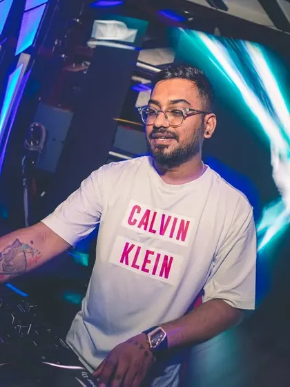Dialed in and focused on the mix at a packed club. The right lighting and a powerful sound system are key to creating an immersive experience for any party.