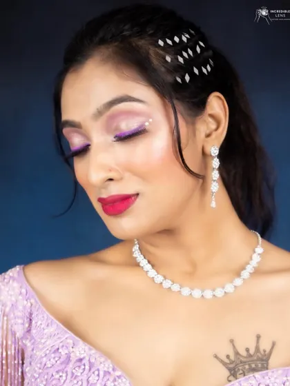 A detailed shot of the lilac eye makeup, with a subtle winged liner and a bright pink lip.