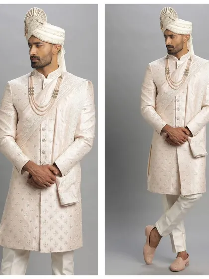 A beautiful pink printed sherwani. This pre-loved piece is perfect for a groom who wants a touch of modern flair on his wedding day.