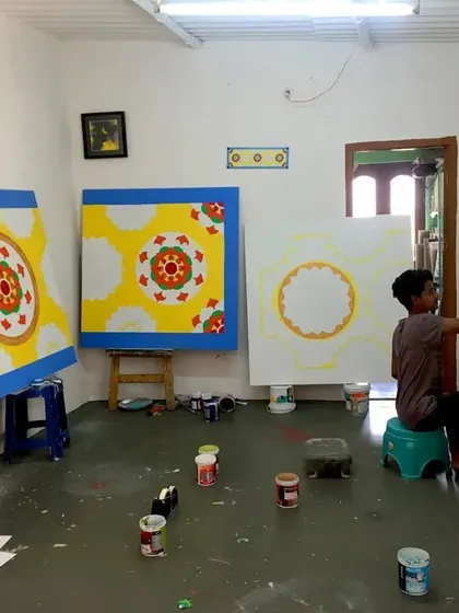 A view of our workshop during the creation of the saree showroom ceiling panels. Multiple large canvases are worked on simultaneously to ensure the entire project is cohesive and completed on schedule.