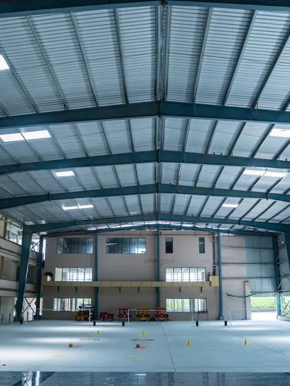 Another view of the multi-purpose hall, showing its immense scale and open-sided design. This structure provides shelter from the elements while maintaining a connection to the outdoors, making it suitable for year-round activities.
