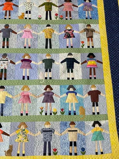 A close-up of the paper dolls, showcasing their different outfits and the cute cats and flowers.