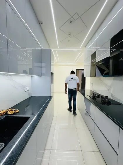 A look at the clean lines and reflective surfaces of this modern grey kitchen. The handleless cabinets and drawers contribute to the sleek, minimalist design.