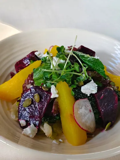 A vibrant beetroot and orange salad with feta cheese and pumpkin seeds. A refreshing and healthy tapas option.