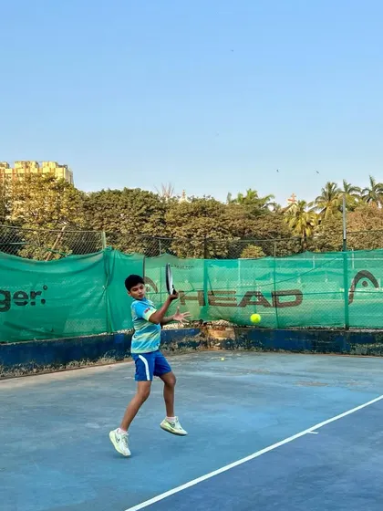 A young player connects with the ball, showcasing the timing and coordination we develop in our junior batches.