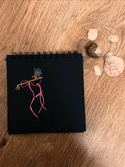 A minimalist doodle of Lord Krishna playing his flute, created with simple lines on black paper.