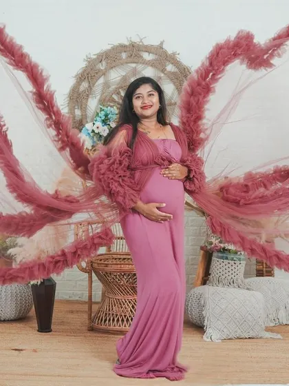 Let's get creative. I love using flowing gowns to create artistic effects, like these beautiful wings, to celebrate the angelic feeling of motherhood.