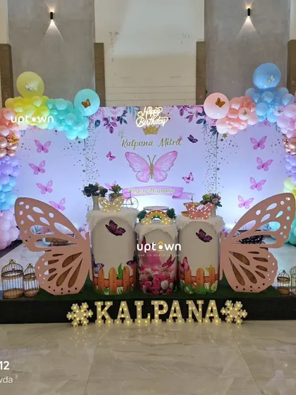 A lovely butterfly theme with pastel rainbow balloons and large wing props.