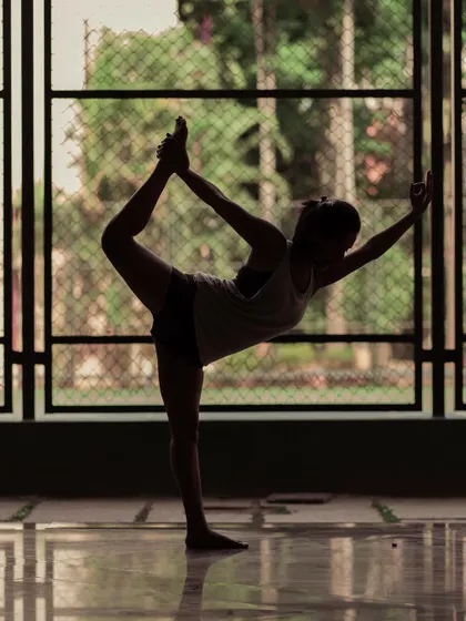 A silhouette of Natarajasana, the Lord of the Dance Pose. This powerful asana is named after Shiva's cosmic dance and teaches us to find grace and stillness even in dynamic action.