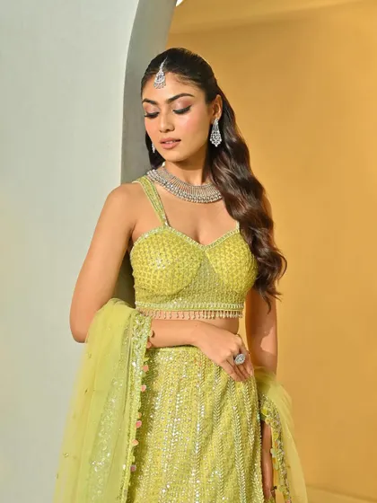 The soft waves beautifully complement the bride's sparkling lime green lehenga and diamond jewelry.